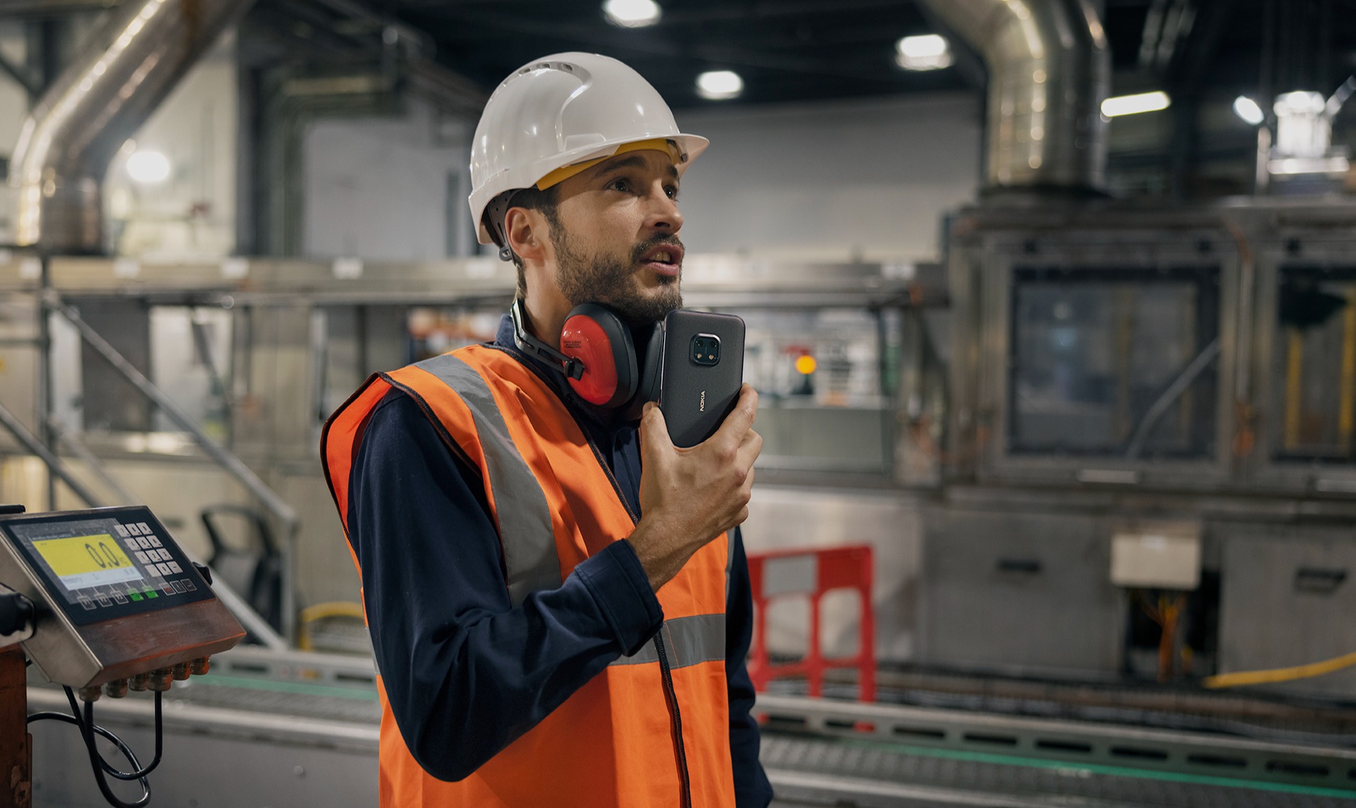 industrial worker holding mobile phone